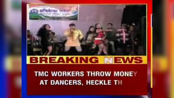 Party workers throw money at women dancers during TMC celebrations 