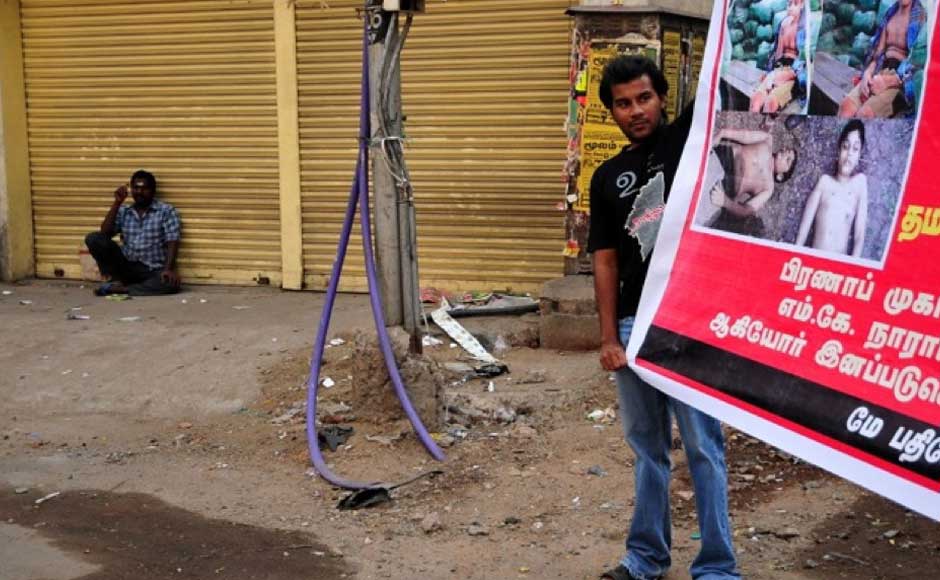 A protester holds up a banner condemning the war crimes in Sri Lanka over which they believe the Congress has done little. Firstpost. A protester holds up a banner condemning the war crimes in Sri Lanka over which they believe the Congress has done little. Firstpost.