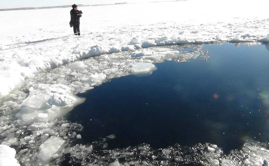 A circular hole in the ice of Chebarkul Lake where a meteor reportedly struck the lake near Chelyabinsk, about 1500 kilometers (930 miles) east of Moscow, Russia. A meteor streaked across the sky and exploded over Russia's Ural Mountains with the power of an atomic bomb Friday, its sonic blasts shattering countless windows and injuring nearly 1,000 people. AP