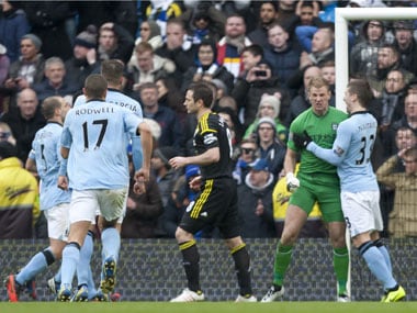 Manchester City's goalkeeper Joe Hart, center right, celebrates with teammates after saving a penalty from Chelsea's Frank Lampard during their English Premier League soccer match at The Etihad Stadium, Manchester on Sunday. AP