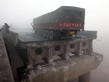 A truck sits on the expressway bridge which partially collapsed due to the explosion. AP