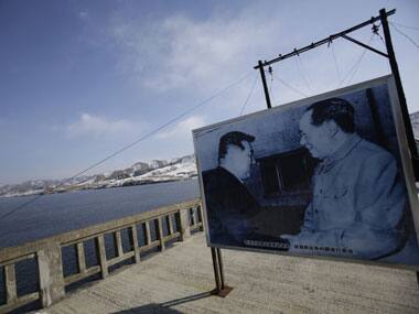 A picture of Mao Zedong, founder of the People’s Republic of China, right, and North Korea’s late leader Kim Il Sung is displayed on the Hekou Bridge, which once linked the two countries. AP