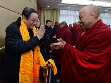 In this Jan. 8, 2013 photo released by China's Xinhua News Agency, Yu Zhengsheng, left, a Standing Committee member of the Political Bureau of the Communist Party of China (CPC) Central Committee, is greeted by a participant during a seminar held with Tibetan Buddhist representatives in Ganzi Tibetan. AP