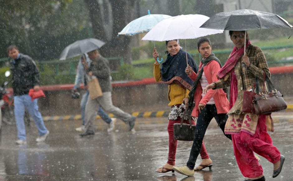 Pedestrians cross a road as it rains in Delhi on Tuesday. AFP Pedestrians cross a road as it rains in Delhi on Tuesday. AFP