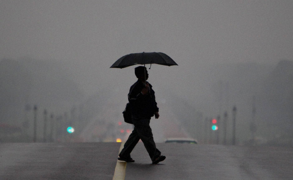 A man crossing the road at Raisina Hill on a gloomy morning. PTI A man crossing the road at Raisina Hill on a gloomy morning. PTI