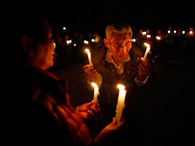 An elderly exile Tibetan participates in a candle-lit vigil in solidarity with fellow Tibetans who have self immolated, in Kathmandu. Associated Press