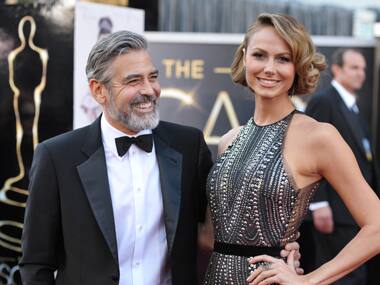 Actor George Clooney, left, and Stacy Keibler arrive at the Oscars at the Dolby Theatre on Sunday Feb. 24, 2013, in Los Angeles. AP