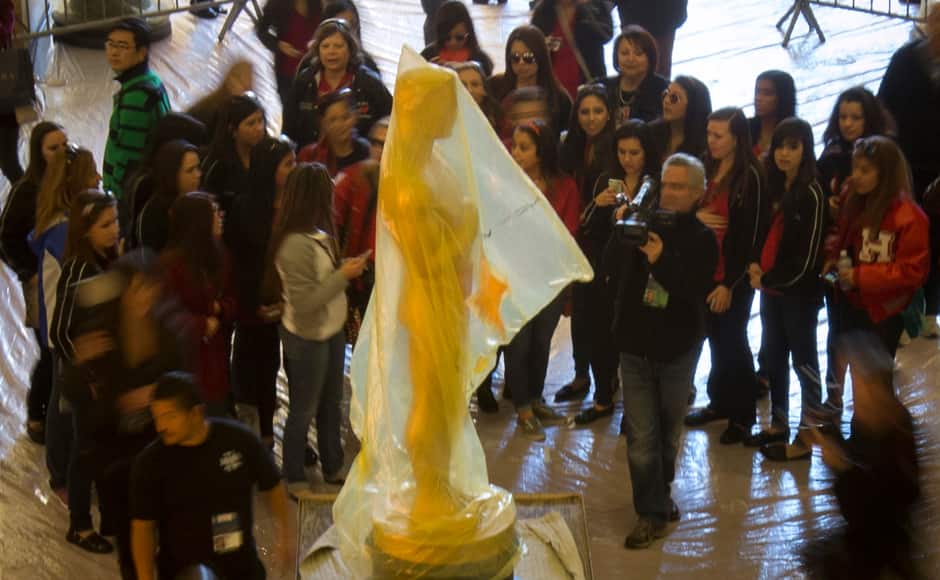 Visitors crowd around a large Oscar statue which was being transported along the path to the Dolby Theatre, the site for the 85th Academy Awards in Los Angeles, California February 21, 2013. Reuters 
