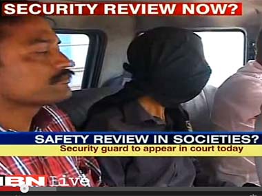 The accused (faced covered) when he was initially arrested by the police. Screengrab from IBNLive video.