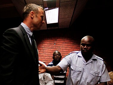 South African 'Blade Runner' Oscar Pistorius (C) is escorted by police during his court appearance in Pretoria. Reuters
