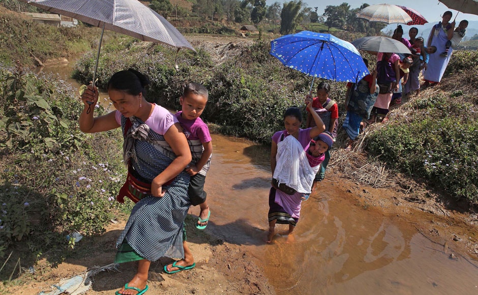 Khasi women carry their babies and walk towards a polling station in Marngar, in the Meghalaya. AP Khasi women carry their babies and walk towards a polling station in Marngar, in the Meghalaya. AP