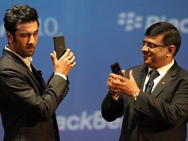 Ranbir Kapoor (L) poses with the BlackBerry Z10 as Managing Director for BlackBerry India, Sunil Dutt looks on at the country launch of the BlackBerry Z10 in Mumbai. AFP 
