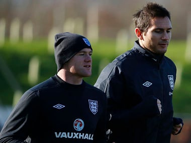 England's Rooney jogs with Lampard during a training session at the St George's Park training complex near Burton Upon Trent. Reuters