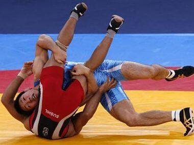 File photo of Japan's Tatsuhiro Yonemitsu (in blue) fighting with India's Sushil Kumar. Reuters