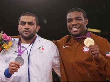 Silver medallist Iran's Sadegh Saeed Goudarzi and gold medallist US' Jordan Ernest Burroughs at the 2012 Olympic Games. Getty