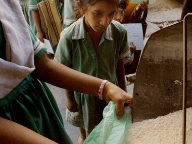 A child queues up in front of a fair price shop in India. AFP.