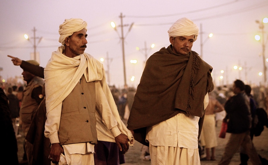 A father-son duo walk at the Kumbh Mela. Trilok Sengupta A father-son duo walk at the Kumbh Mela. Trilok Sengupta