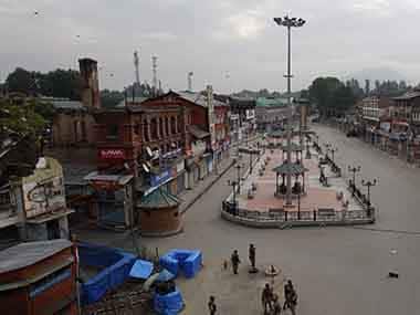 Archive image of Indian policemen standing guard along an empty shopping arcade. Reuters
