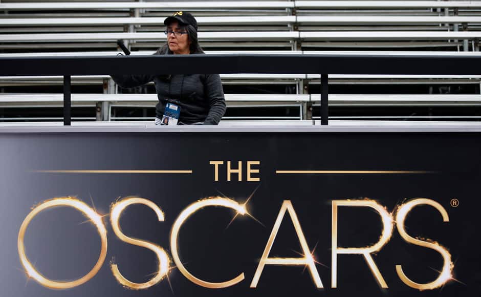 Virginia Belloni paints a rail in the red carpet arrival area outside the Dolby Theatre in the Hollywood section of Los Angeles, Thursday, Feb. 21, 2013. AP