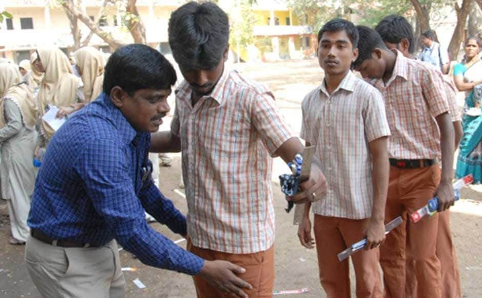 No cheating: Students being checked before they enter the examination hall. Firstpost No cheating: Students being checked before they enter the examination hall. Firstpost