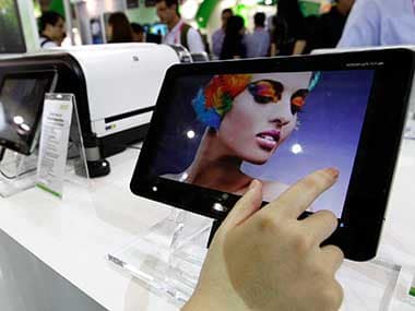 A visitor plays with the Acer Iconia tablet A700 at the Acer booth during the 2012 Computex exhibition at the TWTC Nangang exhibition hall in Taipei. Reuters 