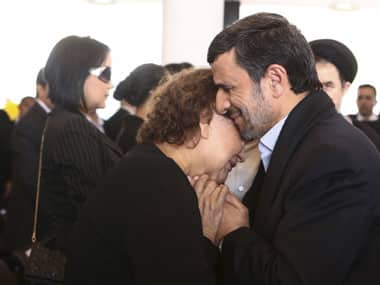 Mahmoud Ahmadinejad comforts Hugo Chavez's mother Elena Frias. AP