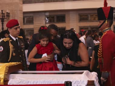 Supporters of Venezuela's late President Hugo Chavez view his coffin during a wake at the military academy in Caracas. Reuters