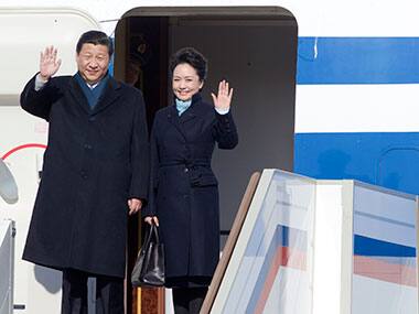 Chinese President Xi Jinping, left, and his wife Peng Liyuan wave upon their arrival to the government airport Vnukovo II, outside Moscow. AP