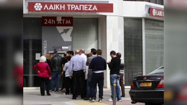 Extra security, limits on transfers as Cyprus banks prepare to reopen