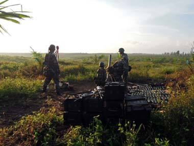 Malaysian soldiers prepare to fire mortars toward the area where a stand-off with Filipino gunmen took place. AP