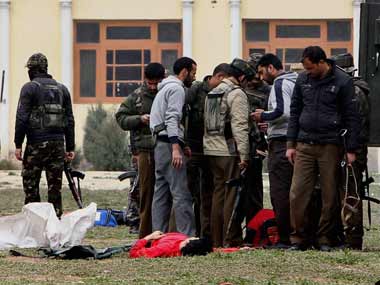Police officials investigate at the attack site in Srinagar. PTI