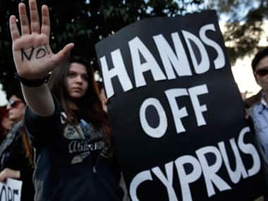 Protesters take part in an anti-bailout rally outside the parliament in Nicosia. Reuters
