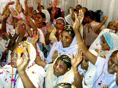 Widows celebrateHoli festival with flower petals at a ashram in Vrindavan near Mathura. PTI