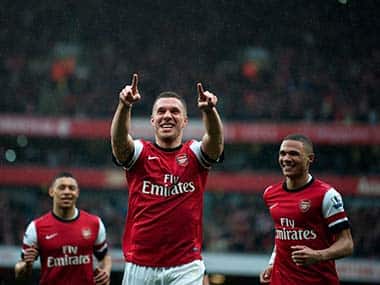 Arsenal's Lukas Podolski, center, celebrates with team mates Alex Oxlade-Chamberlain, left, and Kieran Gibbs, after scoring against Norwich City, during their English Premier League soccer match at Emirates Stadium, London. AP 