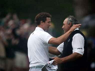 Adam Scott and Angel Cabrera embrace after their playoff, which Scott won. AP