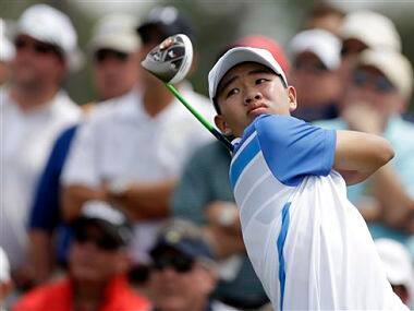 Amateur Guan Tianlang, of China, tees off on the eighth hole during the first round of the Masters. AP