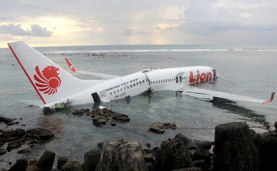 In this photo released by Indonesian Police, a rescue worker stands at the doorway of a crashed Lion Air plane on the water near the airport in Bali, Indonesia on 13 April 2013. AP/PTI In this photo released by Indonesian Police, a rescue worker stands at the doorway of a crashed Lion Air plane on the water near the airport in Bali, Indonesia on 13 April 2013. AP/PTI
