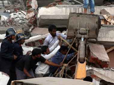 Civilians and fire brigade personnel carry out rescue operation at the building collapse site bat Mumbra in Thane on Thursday. PTI