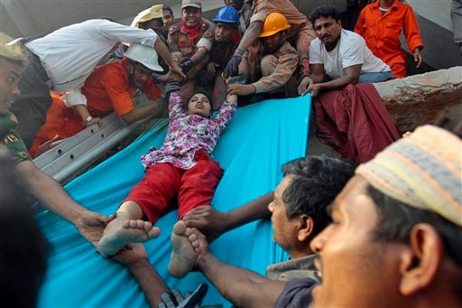 Rescuers lower down a survivor from the debris of a building that collapsed in Savar, near Dhaka, Bangladesh. AP