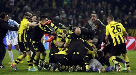 Borussia Dortmund players celebrate after defeating Malaga to win their Champions League quarter-final second leg soccer match. Reuters