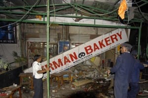 Firefighters examine the site of a bomb blast at the German Bakery restaurant in Pune