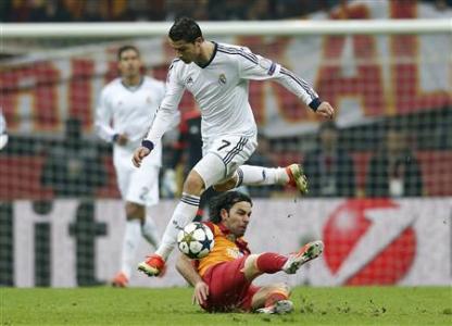 Real Madrid's Cristiano Ronaldo (top) jumps over Galatasaray's Selcuk Inan during their Champions League quarter-final second leg soccer match. Reuters