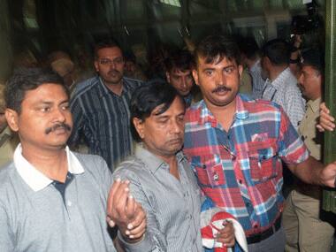 Sudipta Sen being escorted by police. AFP.