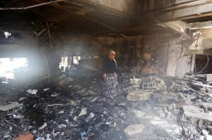A woman walks on scorched rubble in a damaged store at the blast site in Reyhanli in Hatay province, near the Turkish-Syrian border. Reuters.