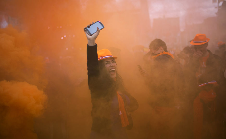 A woman reacts as she watches King Willem-Alexander, Queen Maxima and Princess Beatrix sign the act of abdication outside the Royal Palace in Amsterdam. AP A woman reacts as she watches King Willem-Alexander, Queen Maxima and Princess Beatrix sign the act of abdication outside the Royal Palace in Amsterdam. AP