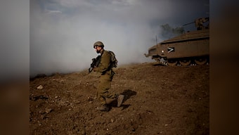 Exchange of fire on Gaza border kills Palestinian gunman, wounds three Israeli soldiers; Hamas military post also targeted during incident