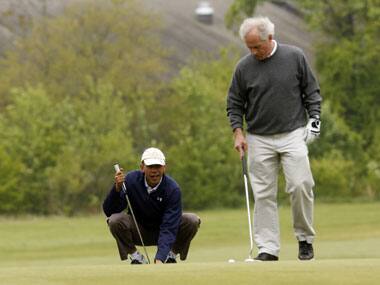 U.S. President Barack Obama lines up his putt as Senator Bob Corker looks on during a round of golf at Joint Base Andrews in Maryland. Reuters
