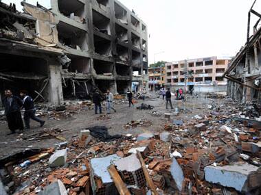 People view the scene at one of the Saturday explosion sites that killed 46 and injured about 50 others, in Reyhanli, near Turkey's border with Syria. AP