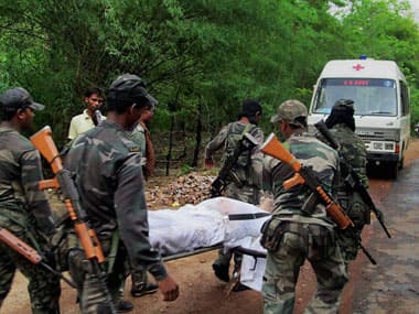 CRPF jawans carry of the body of a victim. PTI