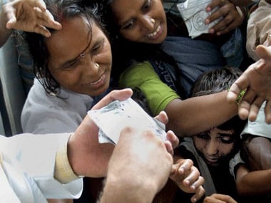People scramble for medication. AFP.